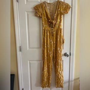 Yellow romper with cute flowers and a front tie. Good condition, size small.
